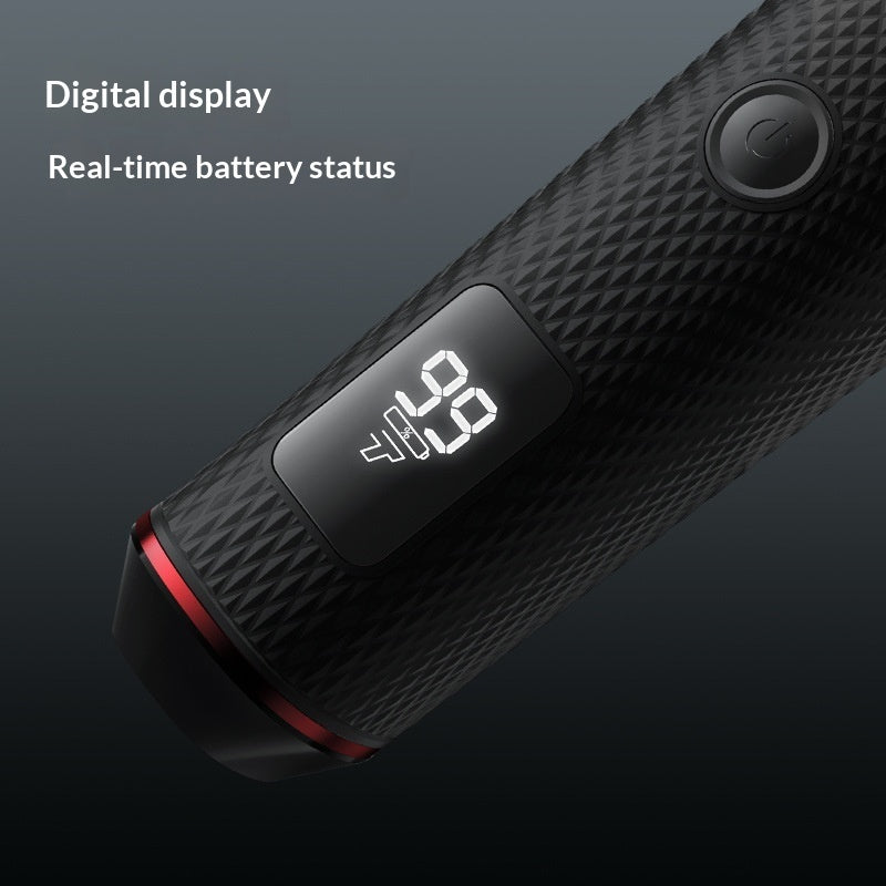 A close-up of a black textured handheld device with a digital battery display showing 100% and a power button, set against a dark gradient background with text reading 'Digital display' and 'Real-time battery status'.