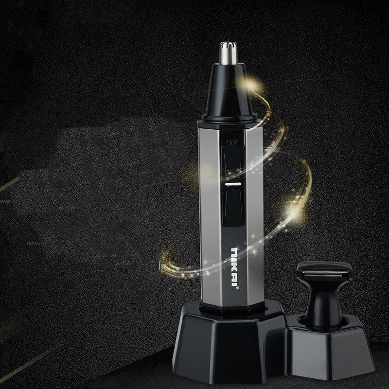 A silver and black facial hair trimmer with a metallic stand, shown alongside a detachable black head on a dark textured background with gold light effects.