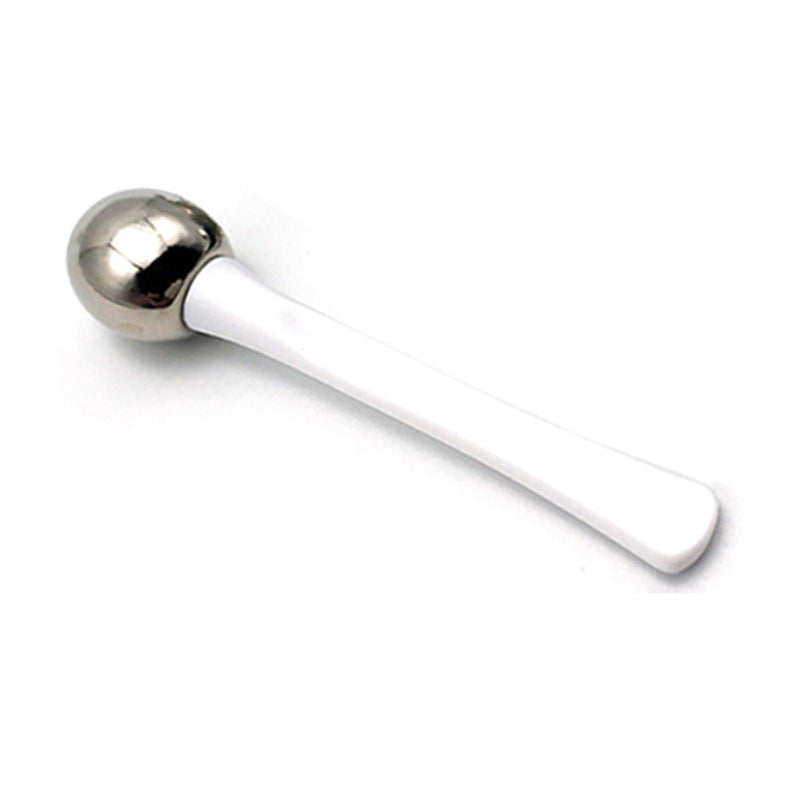 Metallic spoon on a white background