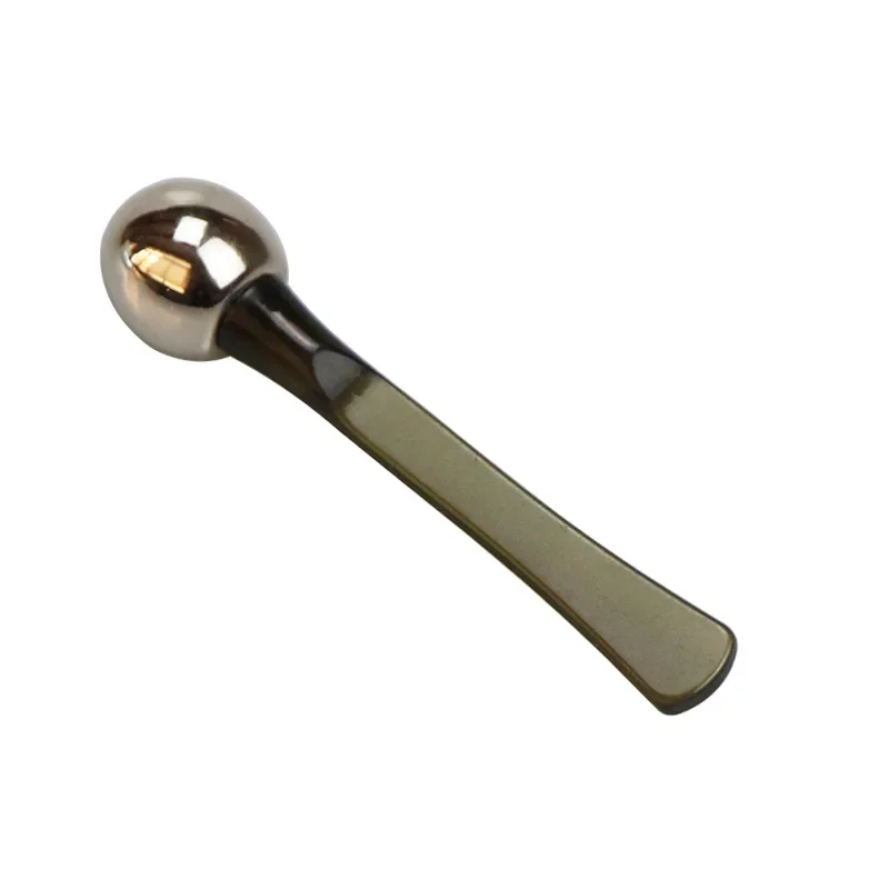 Metallic spoon on a white background