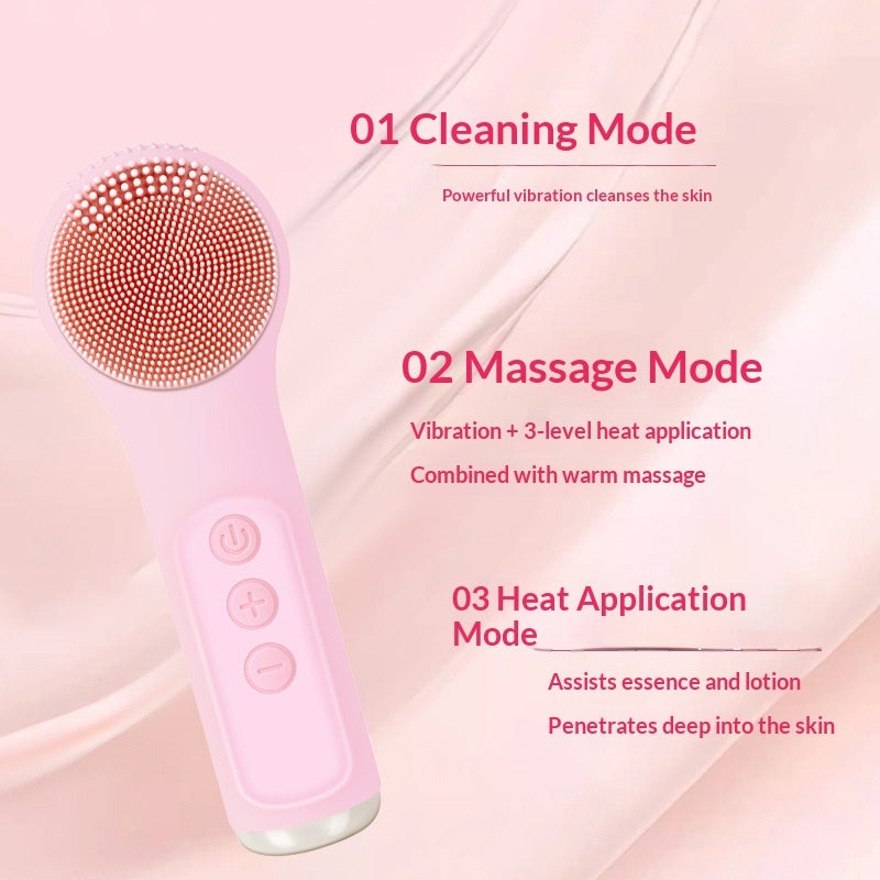 Pink handheld facial cleansing and massage device shown on a soft pink background with descriptive text about cleaning, massage, and heat application modes.