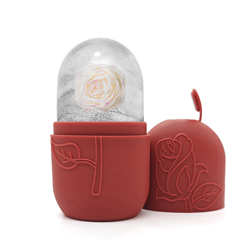 Red container with a snow globe featuring a white rose on a white background