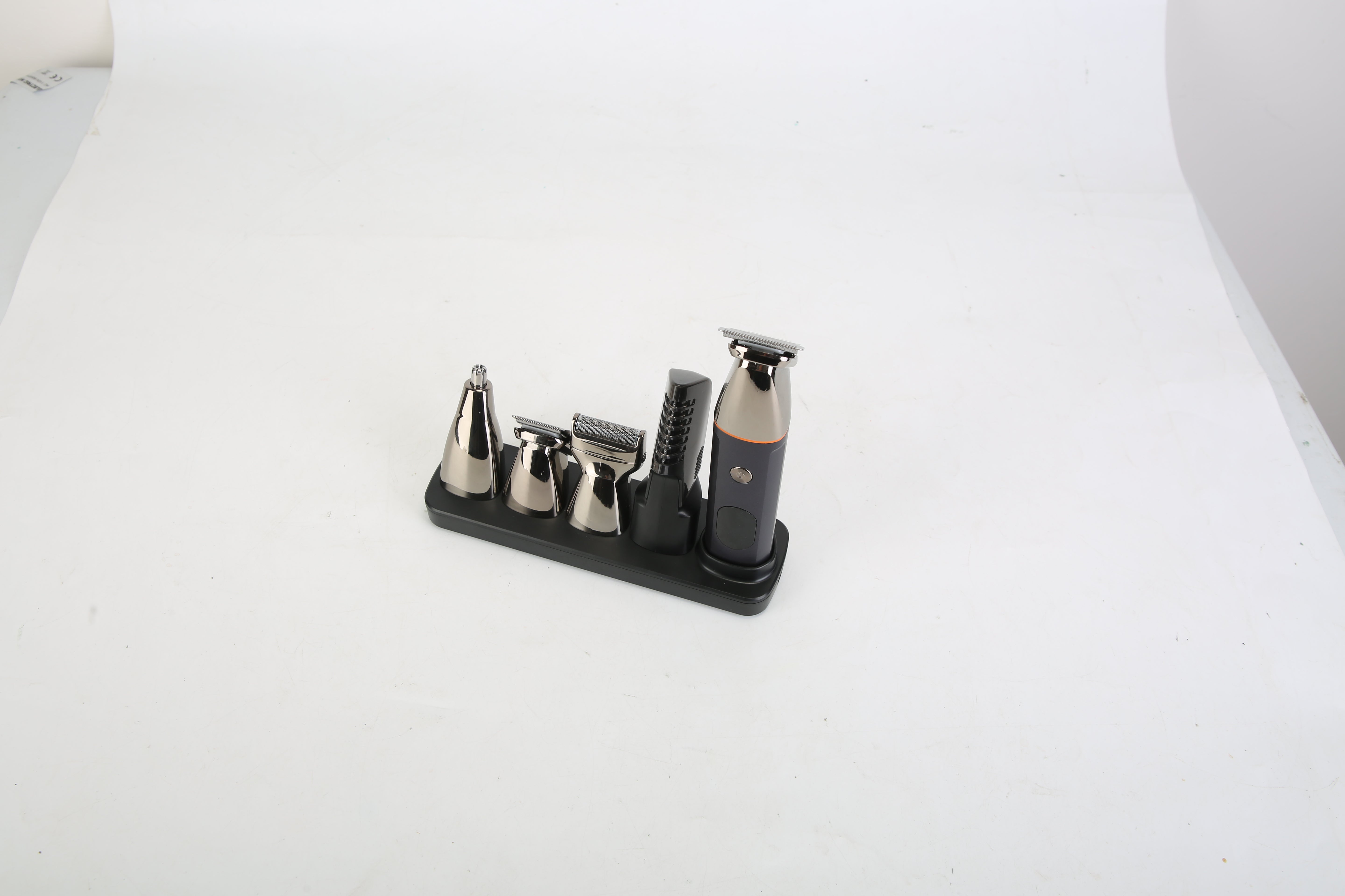 Set of metal tools on a black stand against a white background