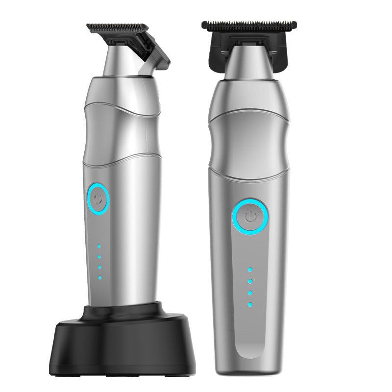 Two silver electric grooming trimmers with black blade attachments and a black charging base, shown on a plain white background.
