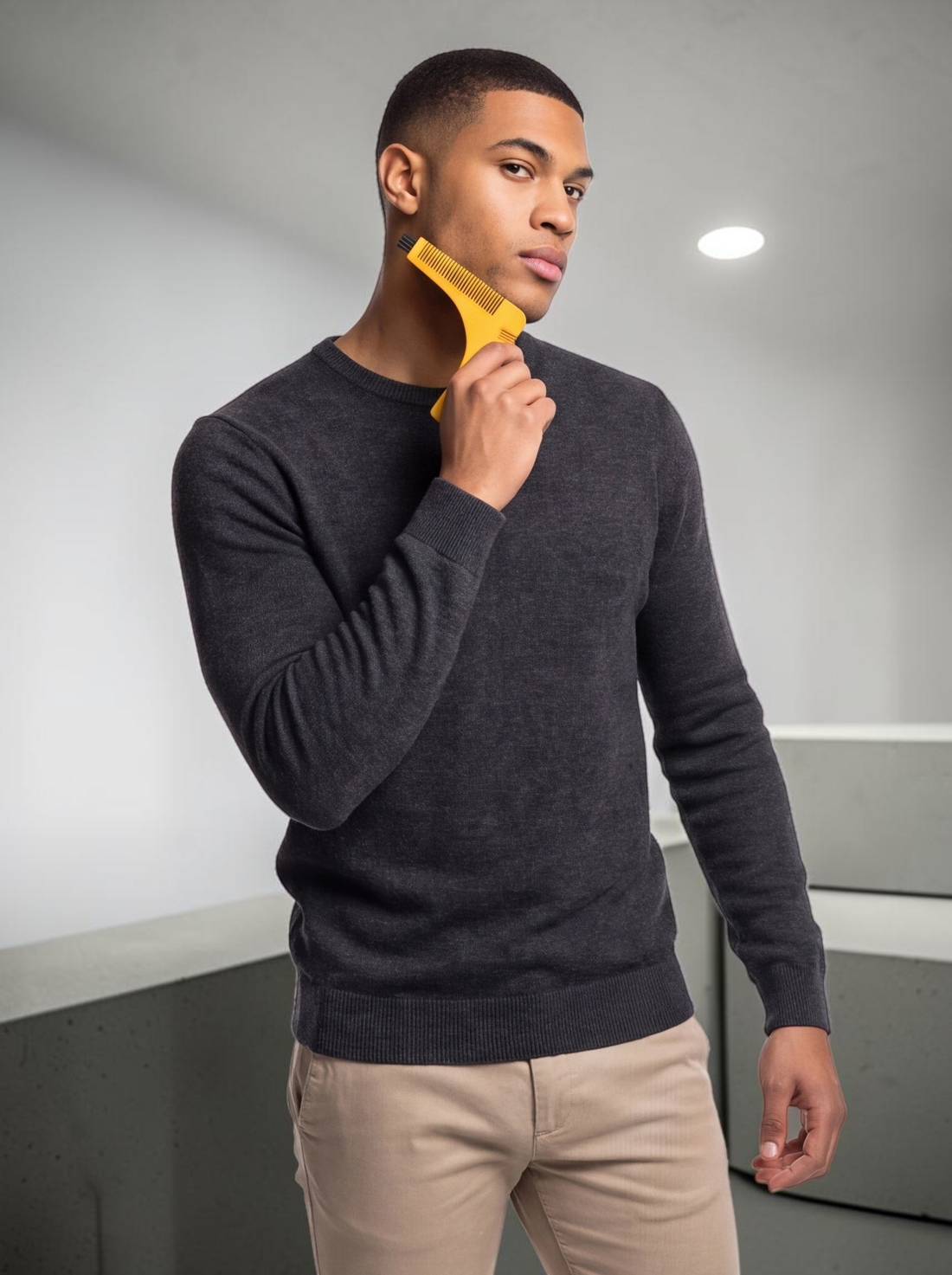 TheGromify yellow beard lining tool used by a man to shape his neckline for a professional, symmetrical shave.