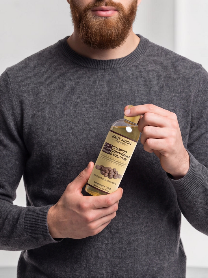 TheGromify Nourishing Beard Conditioner in a clear 100ml bottle held by a man with a well-groomed ginger beard.