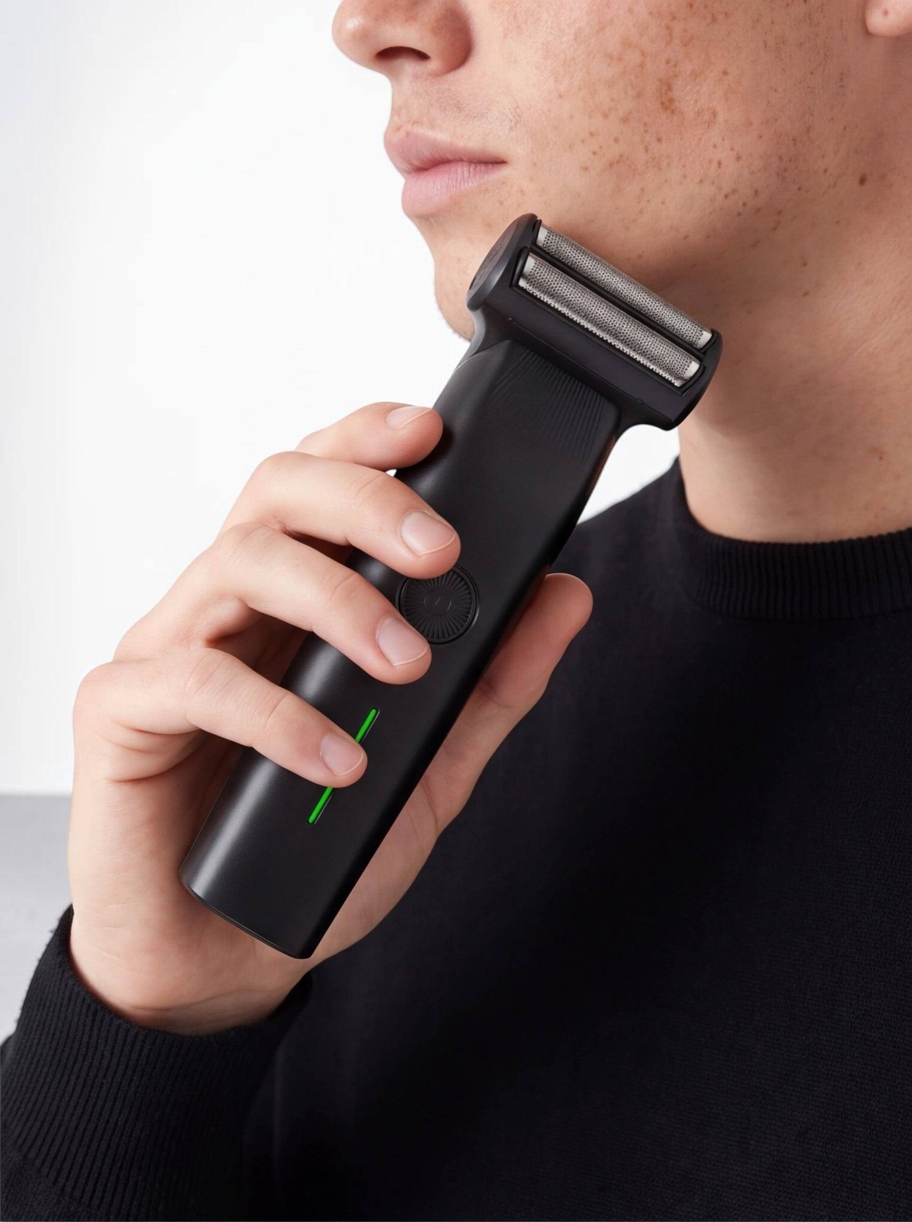 TheGromify 3-in-1 cordless black beard trimmer held by a man for precise facial hair grooming