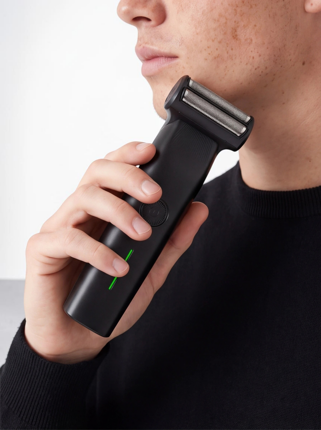 TheGromify 3-in-1 cordless black beard trimmer held by a man for precise facial hair grooming