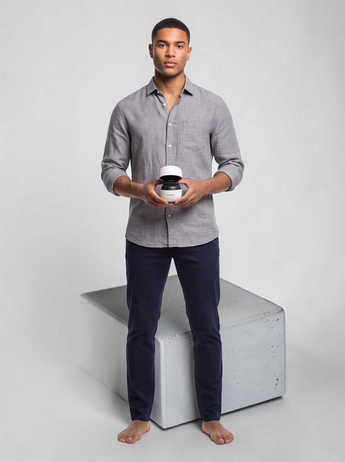 A man holding a TheGromify titanium beard growth derma roller in a white case against a clean studio background.