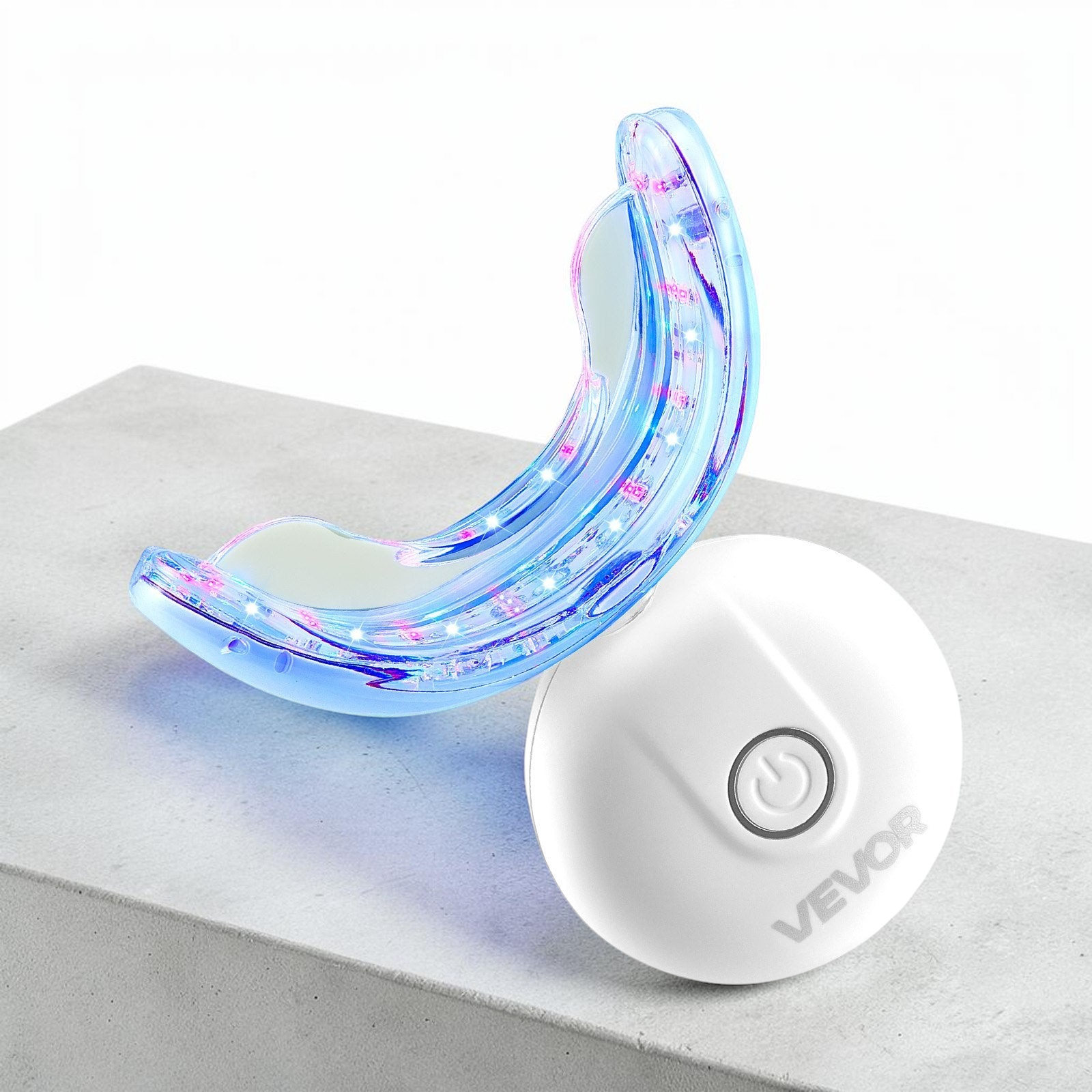 TheGromify 32-LED teeth whitening tray with blue light technology and a white wireless power button on a grey surface.