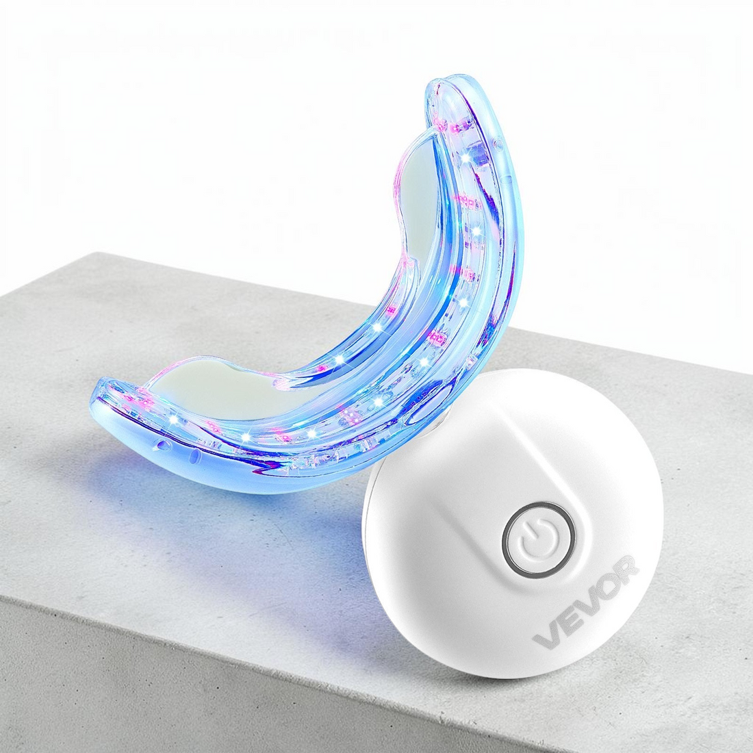 TheGromify 32-LED teeth whitening tray with blue light technology and a white wireless power button on a grey surface.