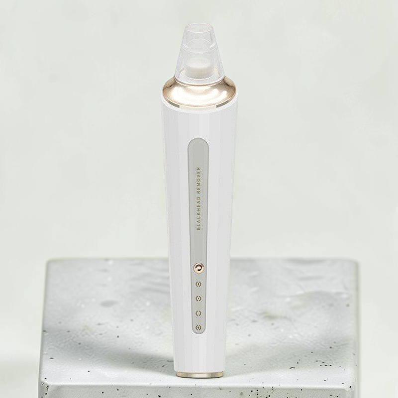 TheGromify electric pore vacuum and blackhead remover in white with gold accents, featuring three suction levels.