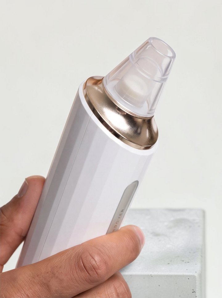 TheGromify electric pore vacuum with white body and rose gold accents for removing blackheads and clearing skin
