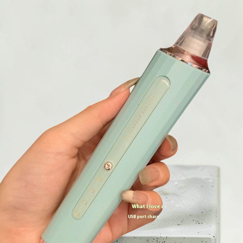 TheGromify electric pore vacuum in mint green with three suction levels for clearing blackheads and congested skin.