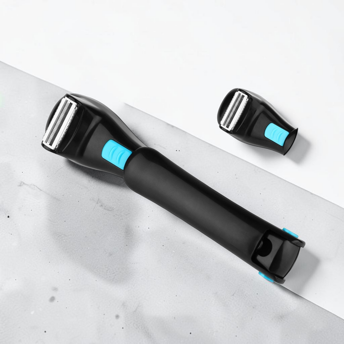 TheGromify long-handle back hair shaver with a foldable black ergonomic design and blue accent buttons.