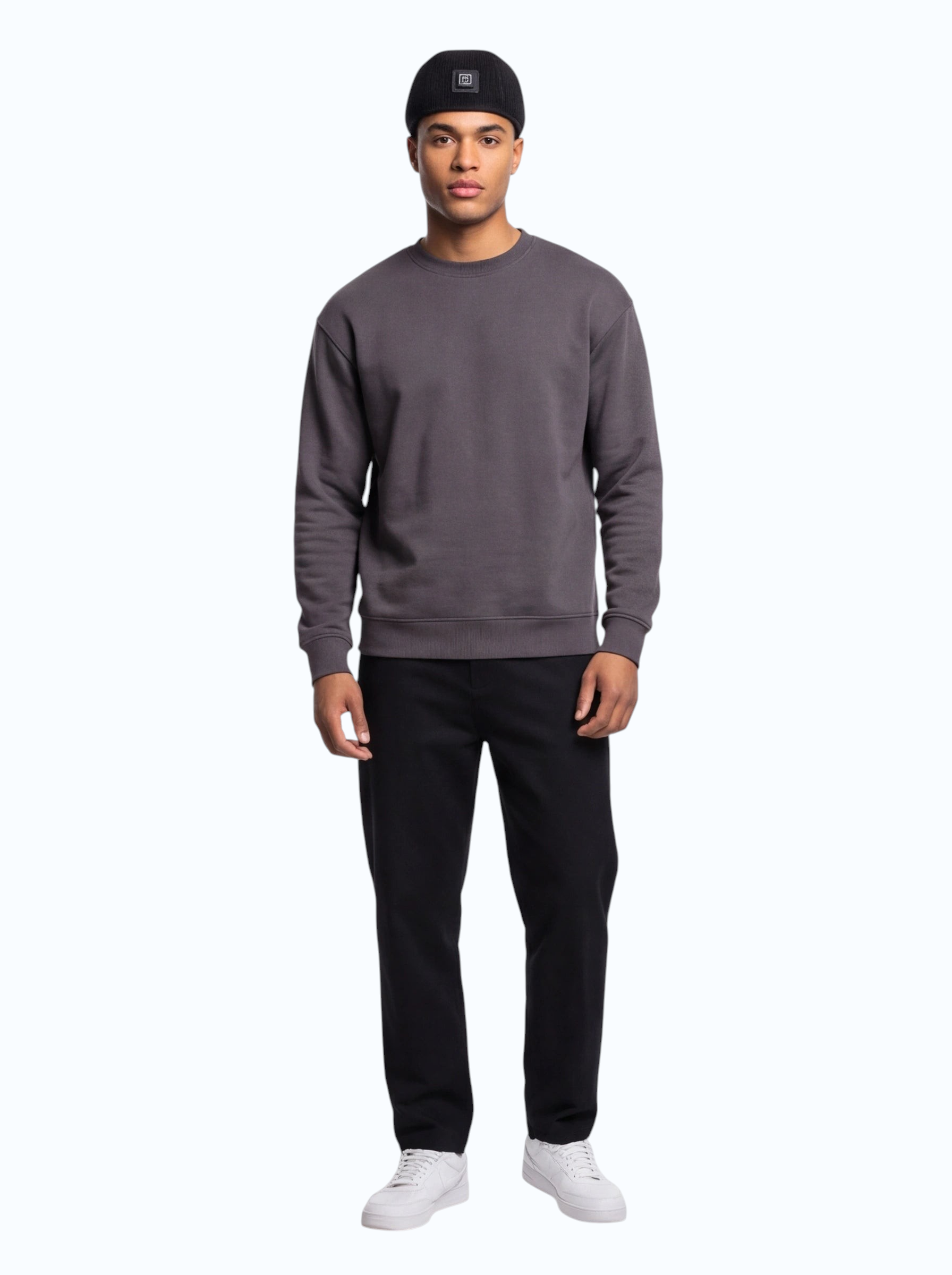 TheGromify infrared LED hair growth cap worn by a man in a grey sweatshirt and black beanie against a white background