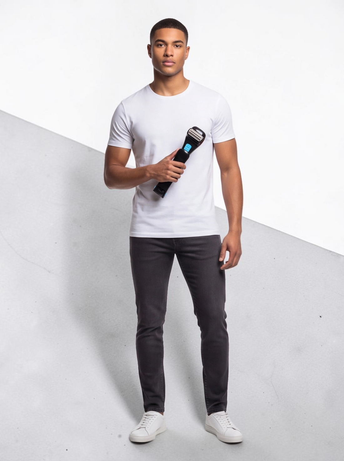 A man holding a black TheGromify long-handle back hair shaver with a foldable design against a white background.