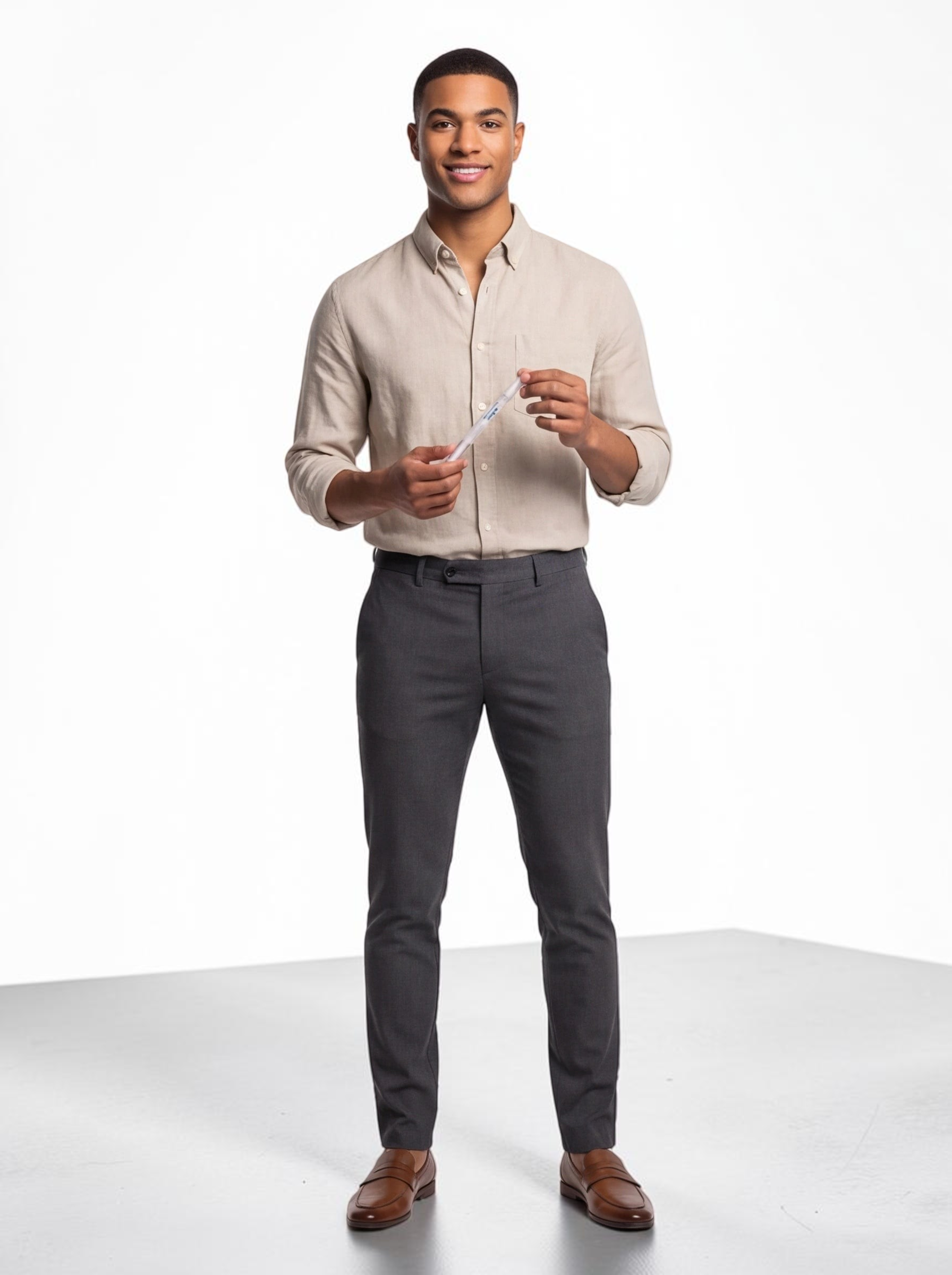 A smiling man in a beige linen shirt holding a TheGromify natural teeth whitening pen against a white background.