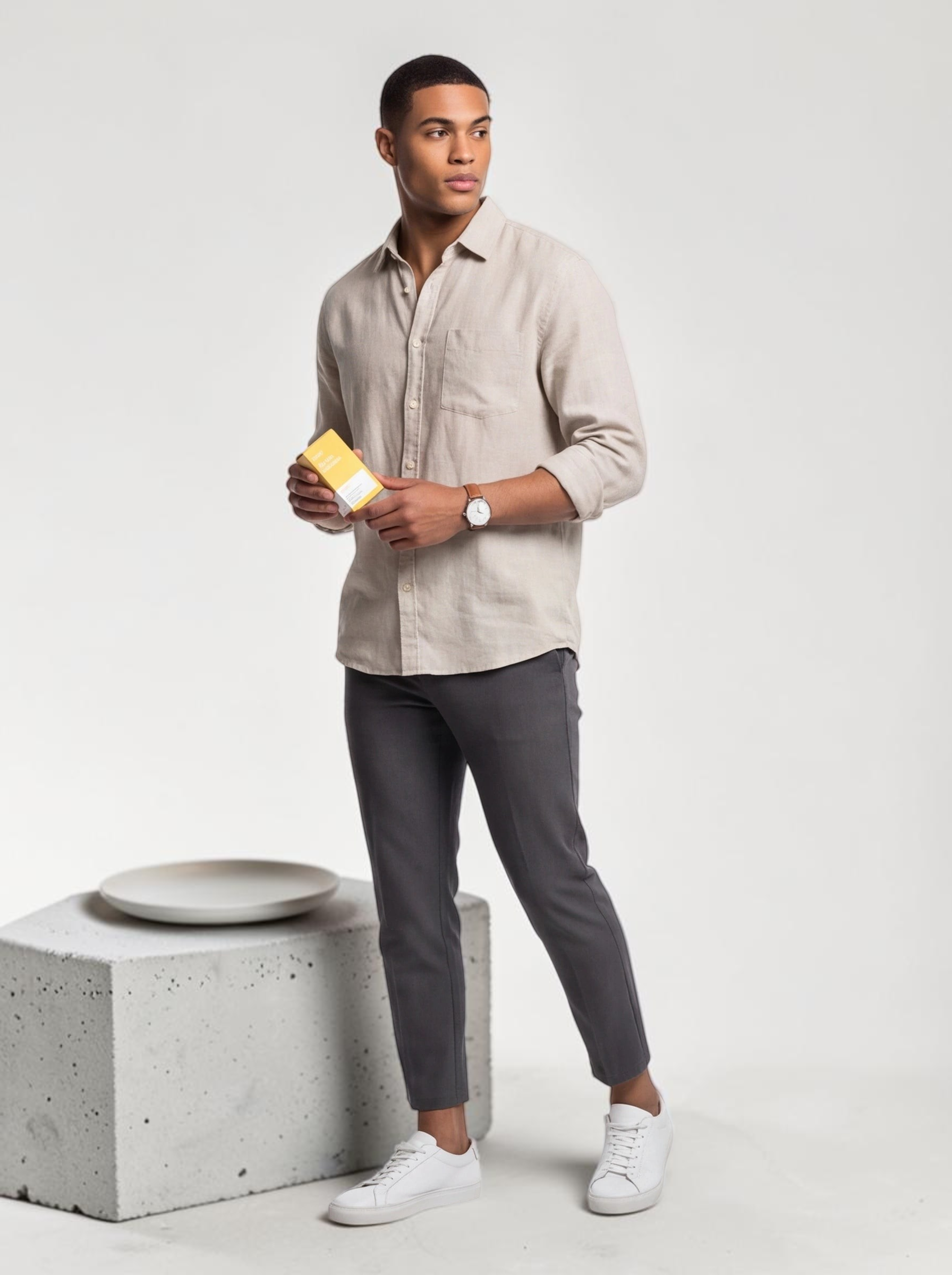 TheGromify Nicotinamide Brightening Face Serum held by a man in a beige linen shirt against a minimalist studio backdrop