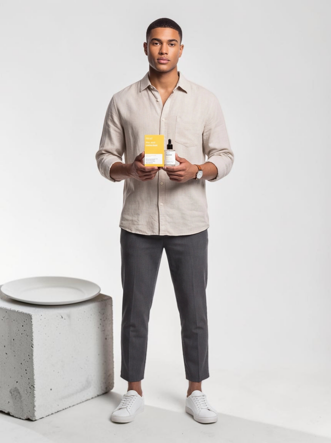 A man holding TheGromify Nicotinamide Brightening Face Serum bottle and yellow box in a studio setting.