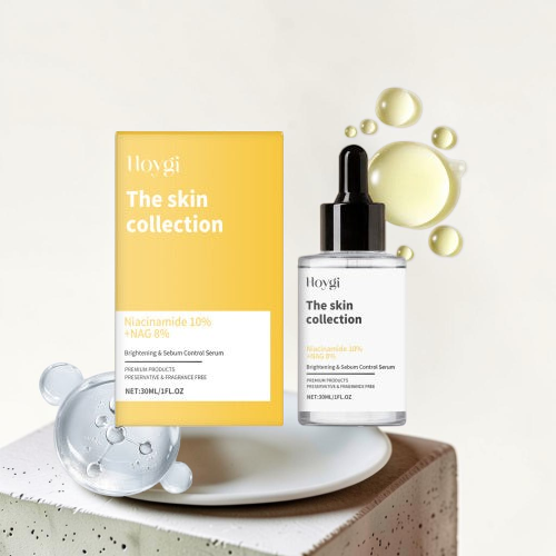 TheGromify Nicotinamide Brightening Face Serum bottle and yellow box on a white platform with serum droplets.