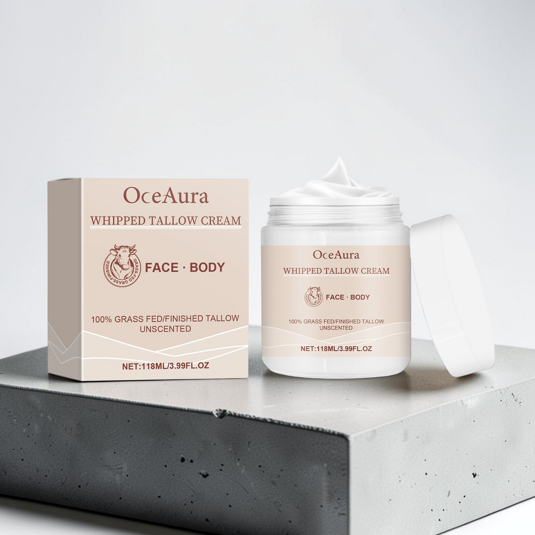 TheGromify OceaAura whipped tallow face and body cream in a jar with its matching beige product box on a concrete base.