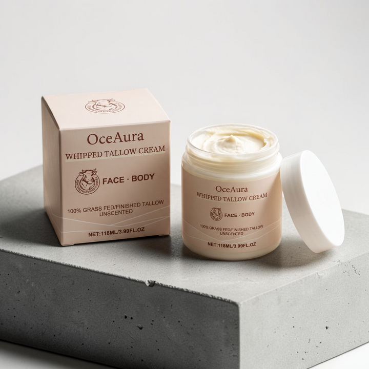TheGromify OceaAura whipped tallow face and body moisturiser in a jar and box on a grey concrete block.