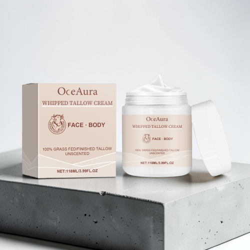 TheGromify OceaAura whipped tallow face and body moisturizer cream in a jar and box on a grey stone pedestal.