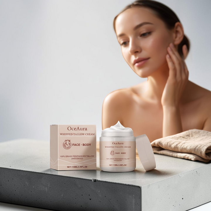 TheGromify OceaAura whipped tallow face and body moisturizer jar and box on a stone surface with a woman in background