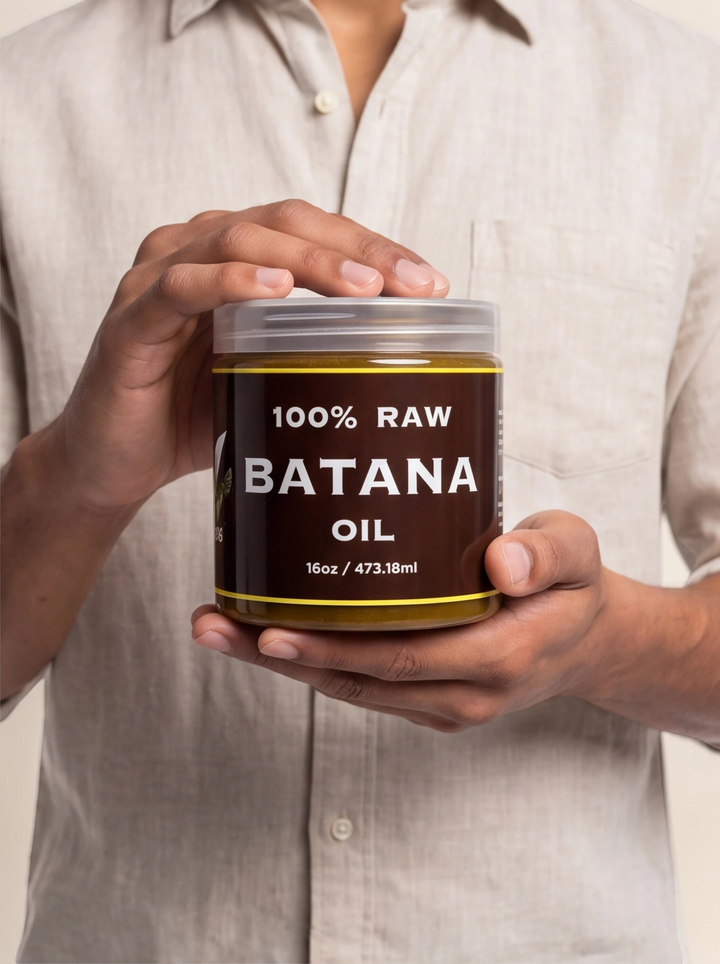 TheGromify 100% raw batana oil hair mask in a 16oz clear jar held by a person wearing a beige linen shirt