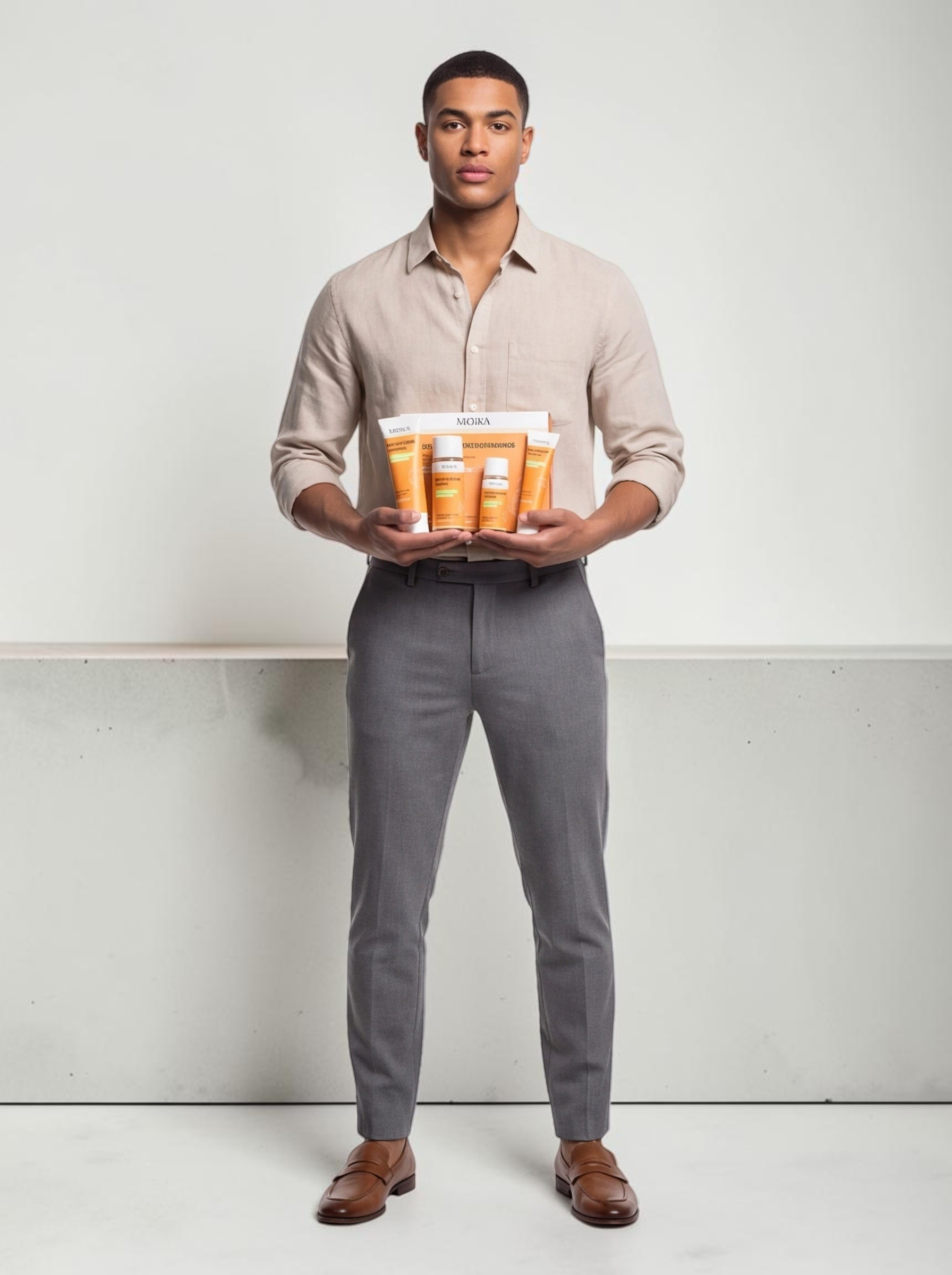 TheGromify Turmeric & Nicotinamide Brightening 4-piece skincare set held by a man in a beige shirt and grey trousers.
