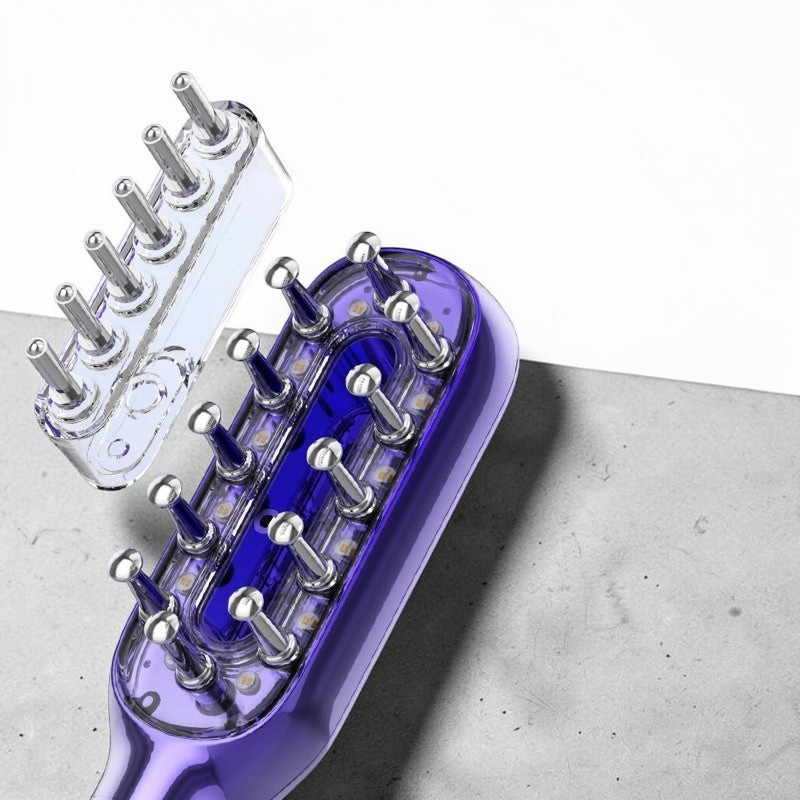 TheGromify vibrating red light hair growth comb with serum dropper attachment for scalp stimulation and hair regrowth.