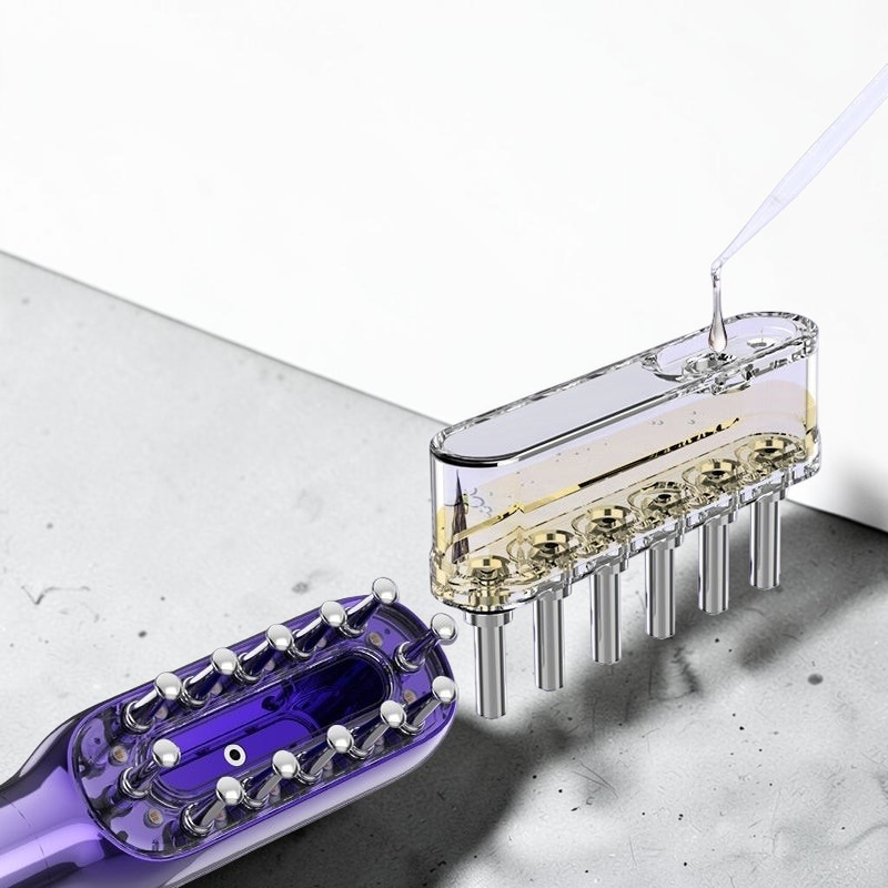 TheGromify vibrating red light hair growth comb with a detachable serum reservoir being filled by a dropper