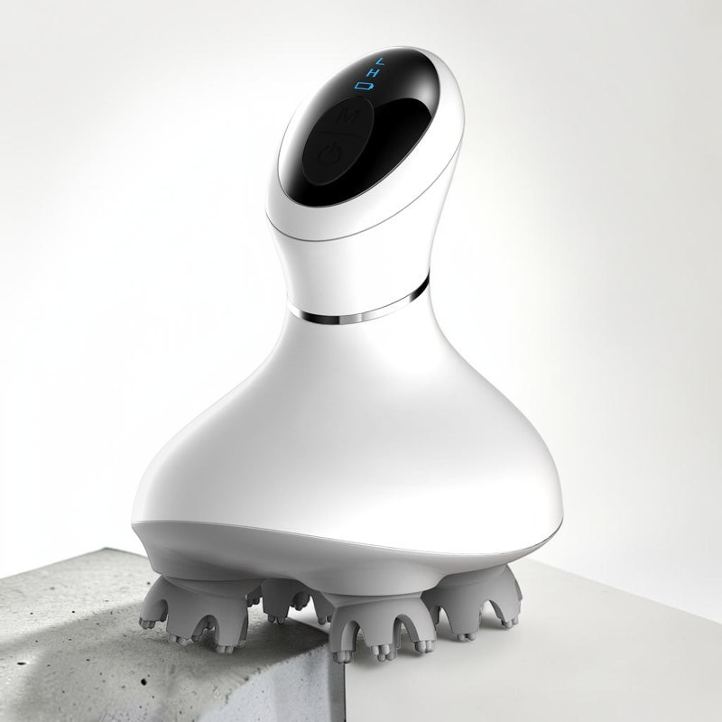 TheGromify wireless electric scalp massager with white ergonomic body and grey 3D kneading nodes on a concrete surface