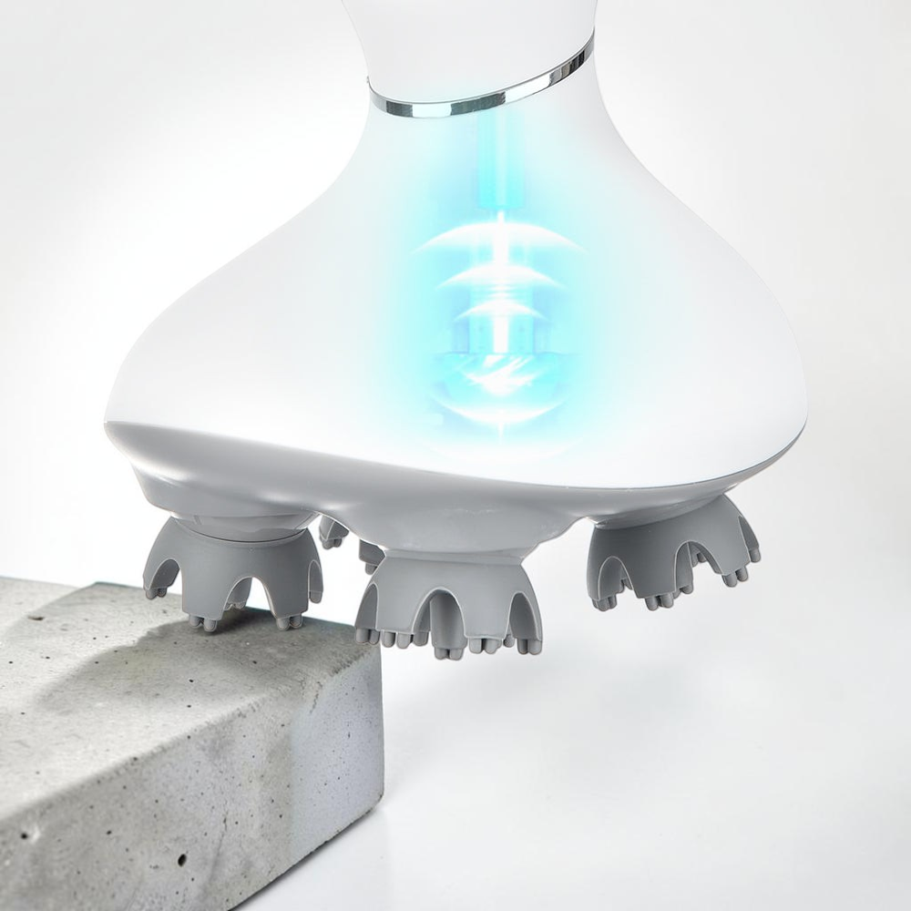 TheGromify wireless electric scalp massager with white body and grey 3D kneading nodes glowing with blue light