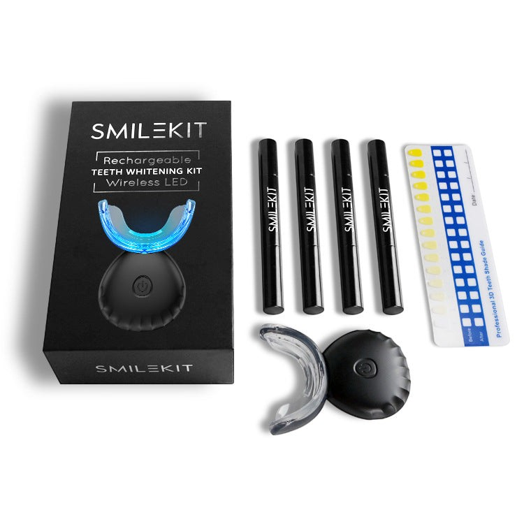 TheGromify wireless LED teeth whitening kit with U-shaped tray, four whitening pens, and a shade guide on white