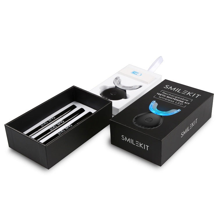 TheGromify wireless LED teeth whitening kit with black packaging, whitening pens, and a blue light silicone tray.