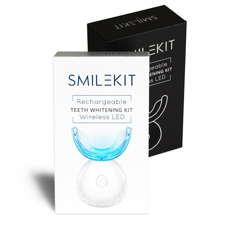 TheGromify wireless LED teeth whitening kit with blue light tray and white rechargeable base in product packaging
