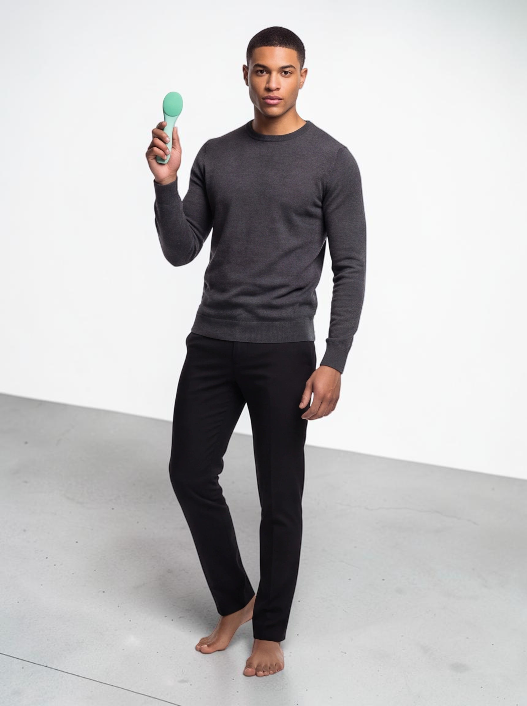 A man holding a green TheGromify ultrasonic silicone cleansing brush for deep pore cleaning and skincare absorption.