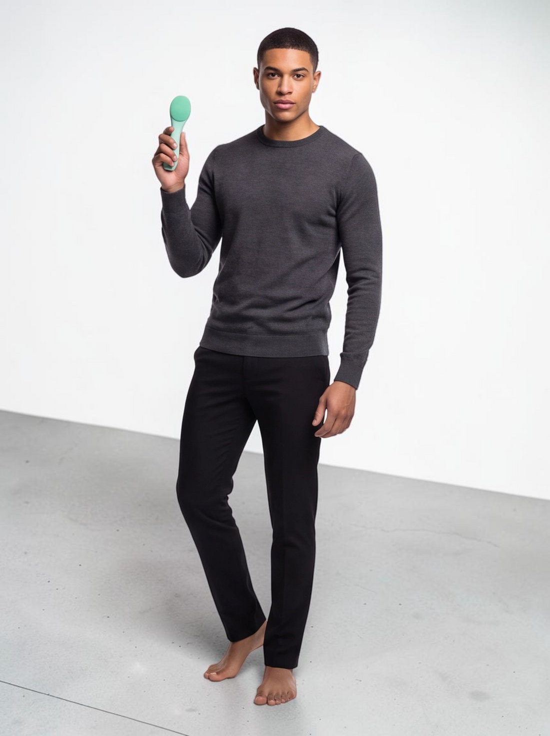 A man holding a green TheGromify ultrasonic silicone cleansing brush for deep pore cleaning and skincare absorption.